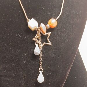 Gold Star Pendant Necklace with White and Orange Accents